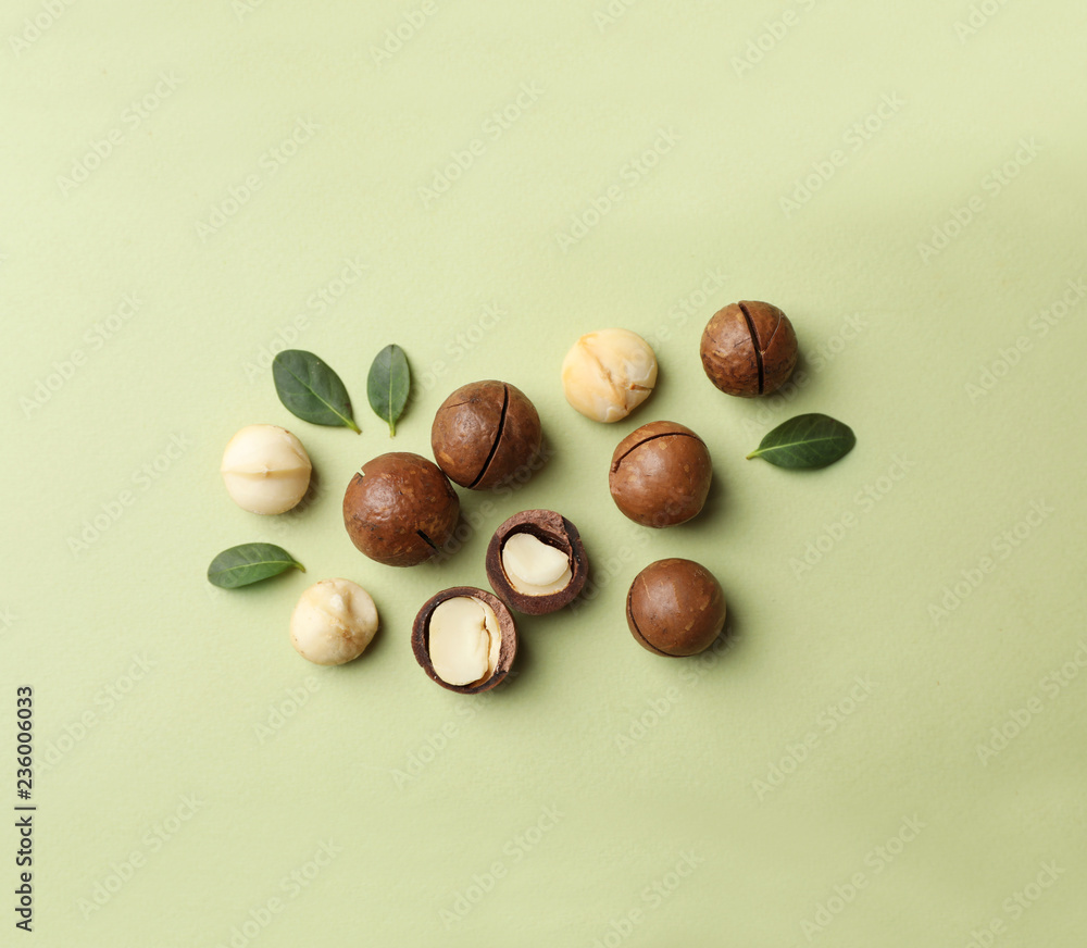 Obraz premium Flat lay composition with organic Macadamia nuts on color background