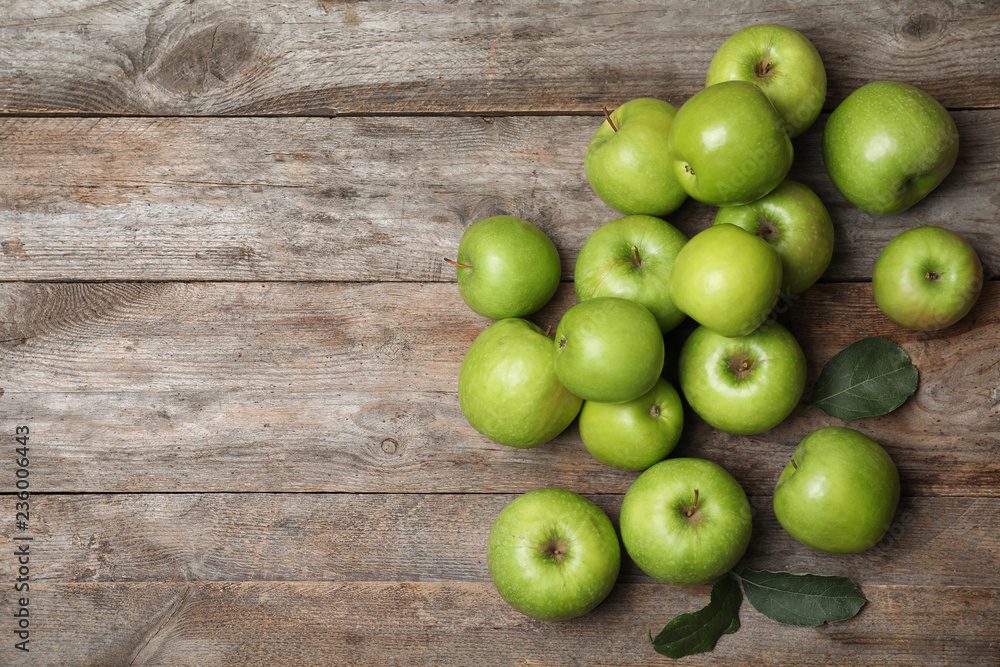 Many juicy green apples and space for text on wooden background, top view Many juicy green apples and space for text on wooden background, top view