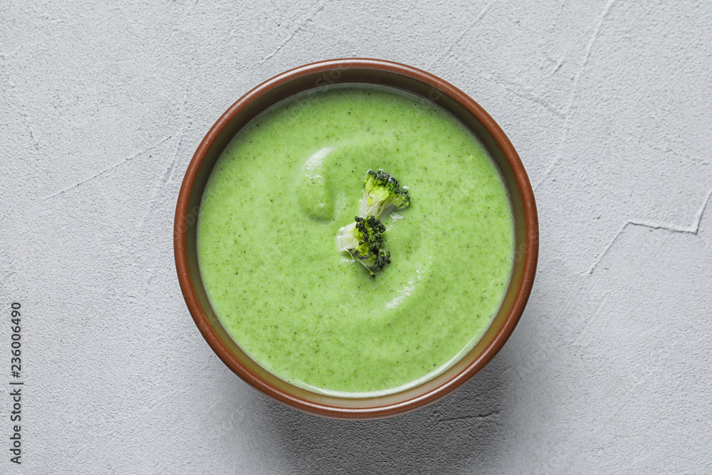Fresh vegetable detox soup made of broccoli in dish on table, top view Fresh vegetable detox soup made of broccoli in dish on table, top view