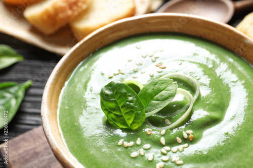Fresh vegetable detox soup made of spinach in dish on table, closeup