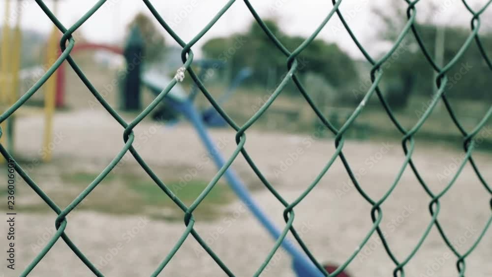 Children playground agains fence Children playground agains fence