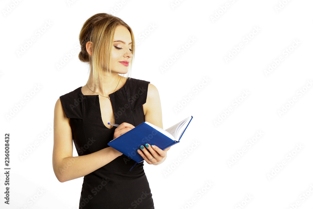 Young beautiful girl in a black dress with a diary, a notepad and a pen in her hands isolated white background. Young beautiful girl in a black dress with a diary, a notepad and a pen in her hands isolated white background.