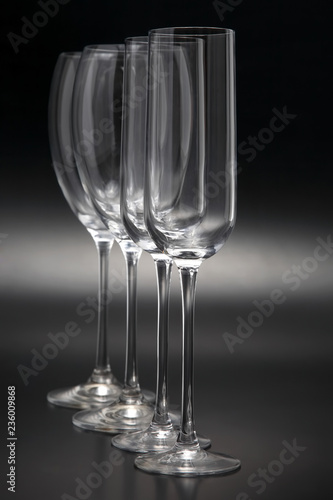 Four wine glasses on a dark background close-up