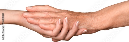 Young Woman's Hand Touching and Holding an Old Woman's Hand