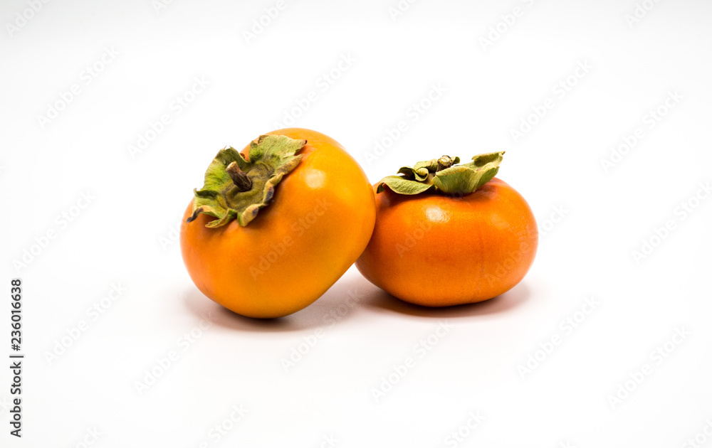 two ripe orange persimmons isolated on white two ripe orange persimmons isolated on white