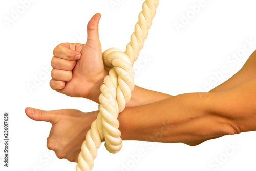 The male hands are tied to the ropes and show the thumb up, like. photo