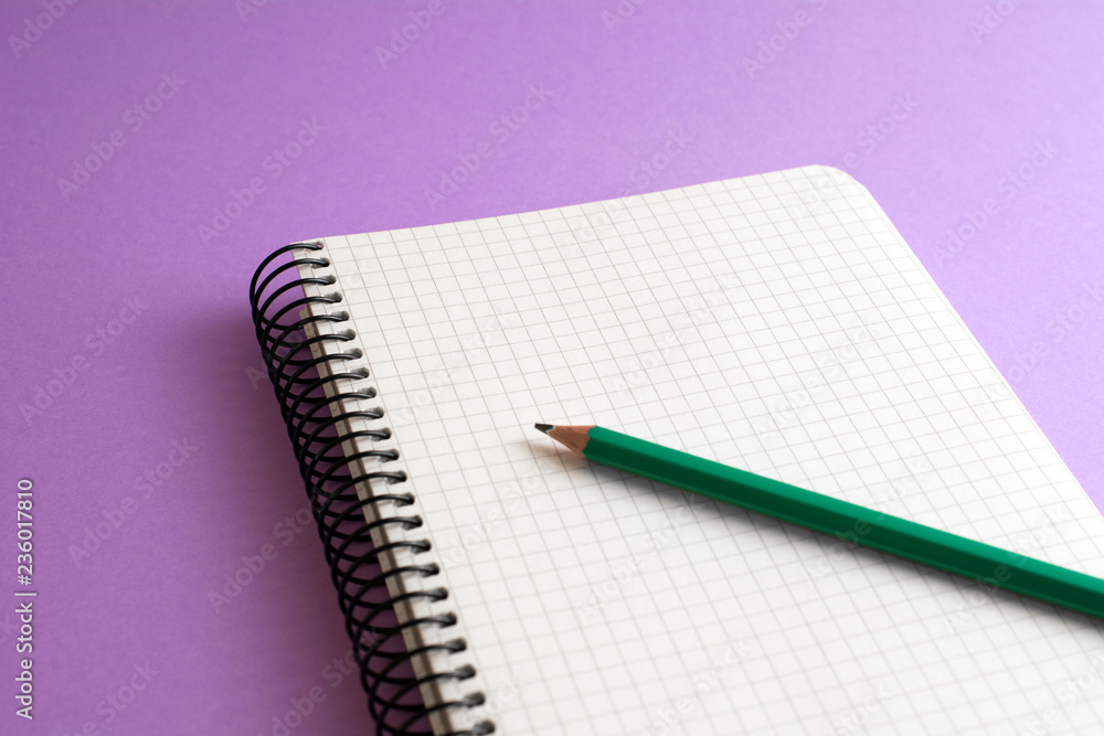 spiral book with green pencil purple background. business concept spiral book with green pencil purple background. business concept