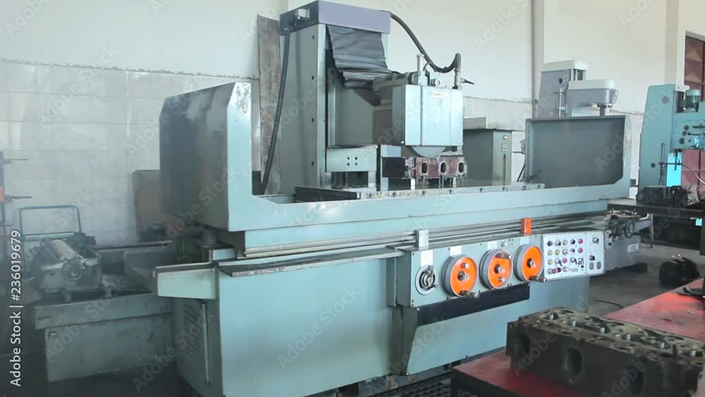 Cylinder head and block resurfacing. Engine block repair process on the grinding machine Cylinder head and block resurfacing. Engine block repair process on the grinding machine