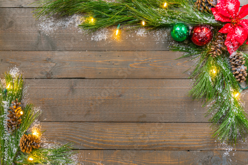 Christmas Background with spruce greens, snow, ornaments and lights