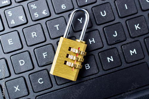 Computer security concept. Padlock on computer keyboard. Selective focus. photo