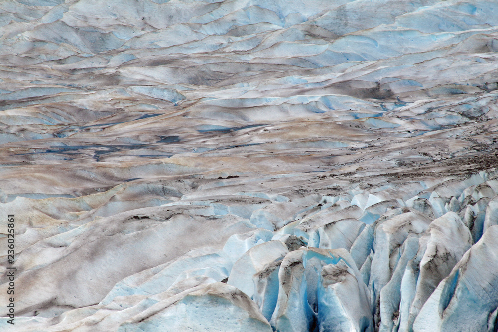 Mendenhall Glacier closeup on an overcast summer day showing the saturated blues of glacial ice. Mendenhall Glacier closeup on an overcast summer day showing the saturated blues of glacial ice.