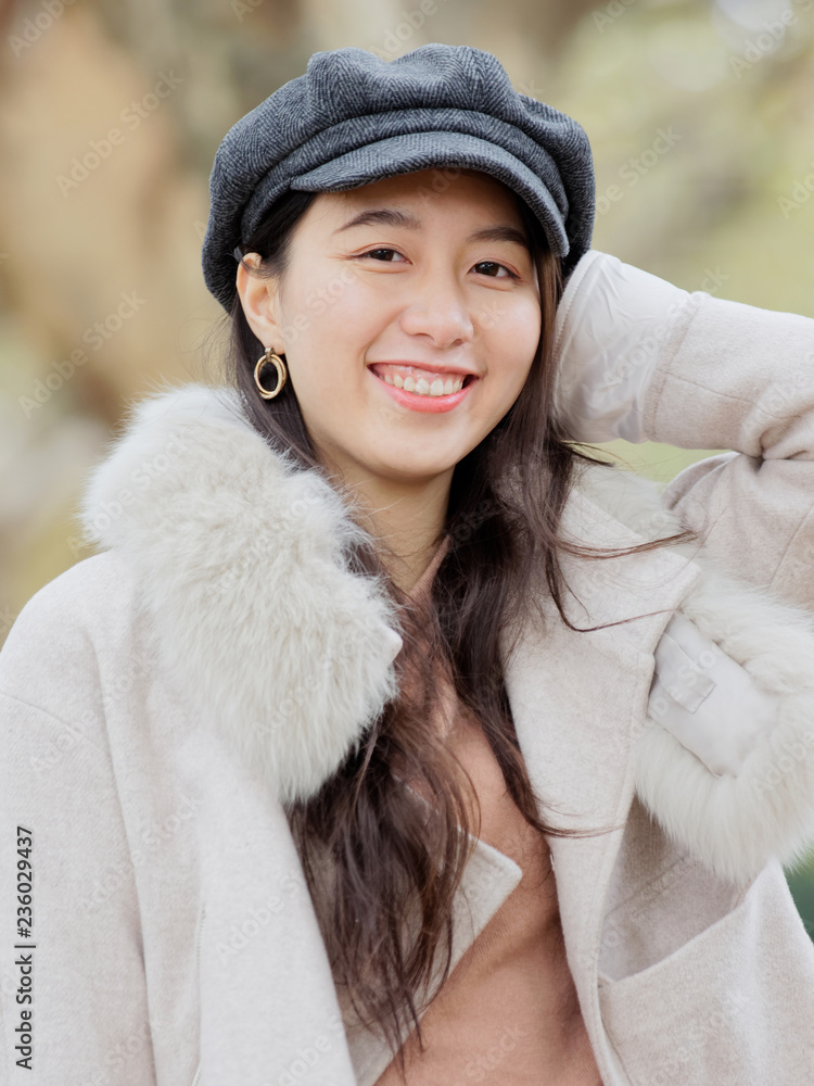 Beautiful young brunette woman in beige coat and blue jean looking and smiling. Outdoor fashion portrait of glamour young Chinese business stylish lady. Emotions, people, beauty and lifestyle concept. Beautiful young brunette woman in beige coat and blue jean looking and smiling. Outdoor fashion portrait of glamour young Chinese business stylish lady. Emotions, people, beauty and lifestyle concept.