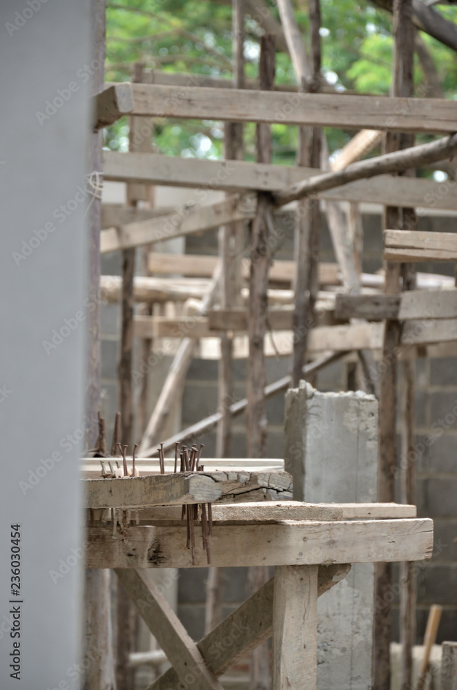 A construction site of a modern house with wooden construction scaffold.