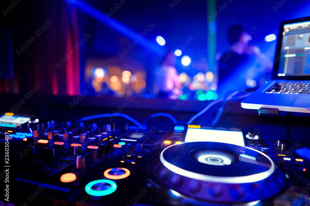 Fototapeta premium DJ stands before the mixer