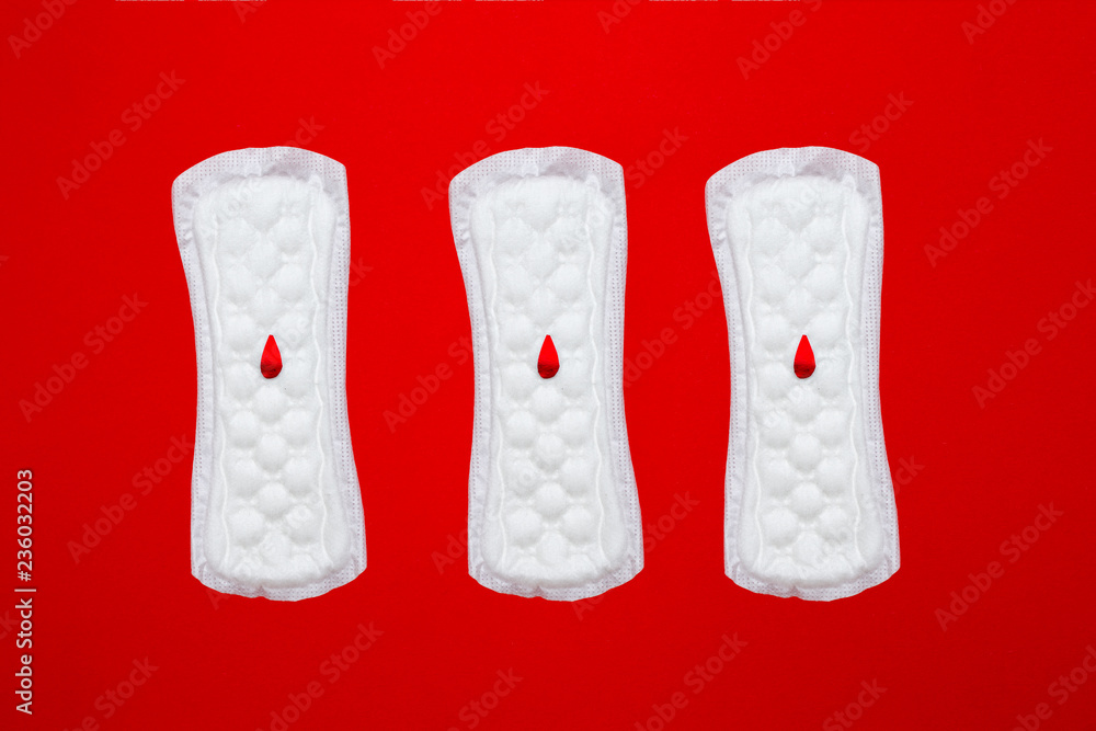 menstruation concept. a menstrual pad on red background menstruation concept. a menstrual pad on red background