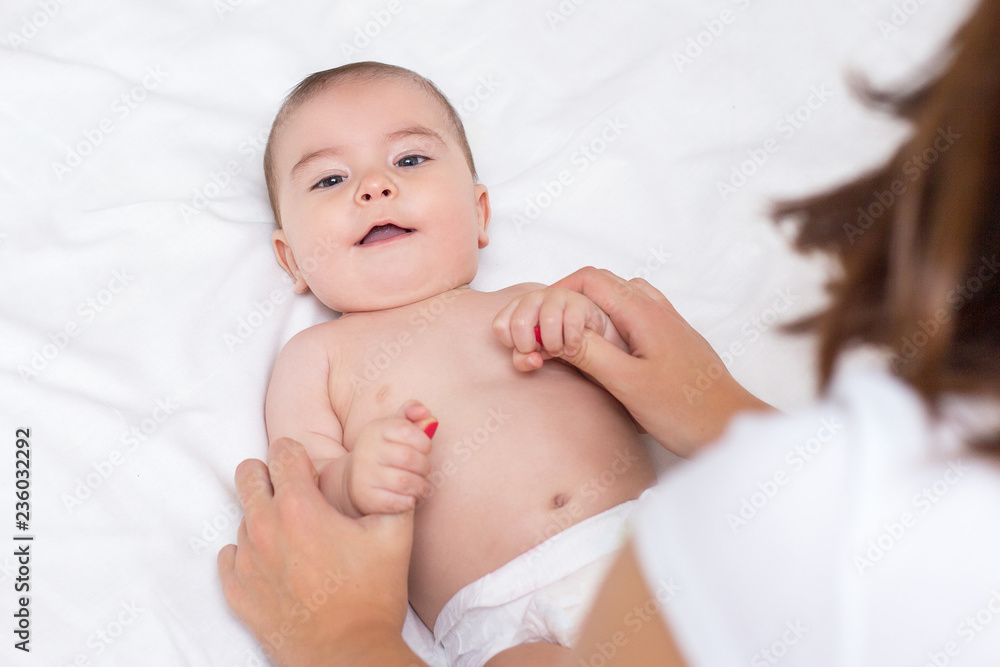 young mother is doing massage for her baby young mother is doing massage for her baby