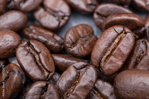Macro shot of whole bean organic smooth medium dark roast coffee from Sumatra on natural stone background