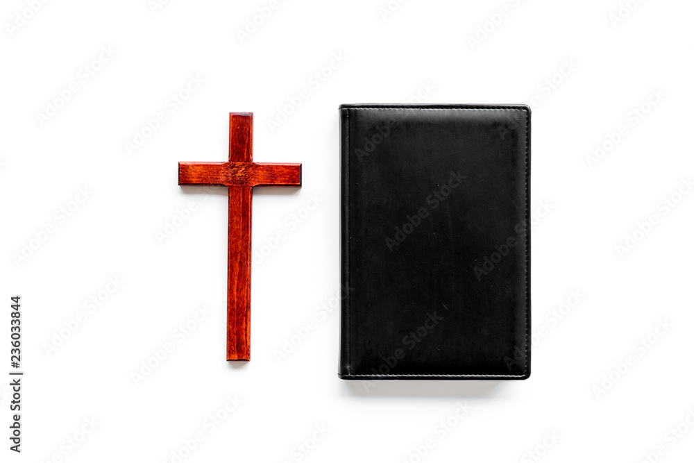 Farewell ceremony, funeral concept. Wooden cross on Bible on white background top view space for text