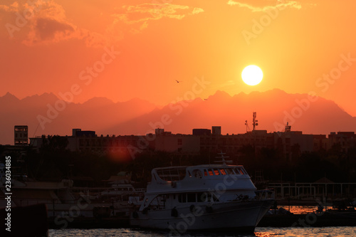Sunset orange and red colors landscape, sea and sun with deep sky background. Red Sea, Egypt, Africa. Evening sunset view with clouds sky. Vacation at summer time. Sunrise morning beauty of nature