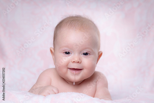 Baby girl smiling. Drooling in a child