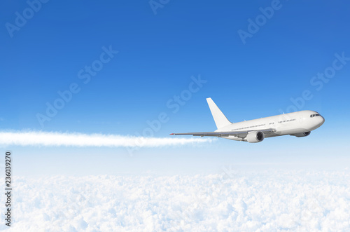 Passenger airplane flying at flight level high in the sky above the clouds