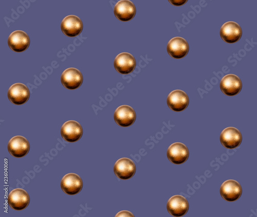 Golden Christmas balls pattern on violet background