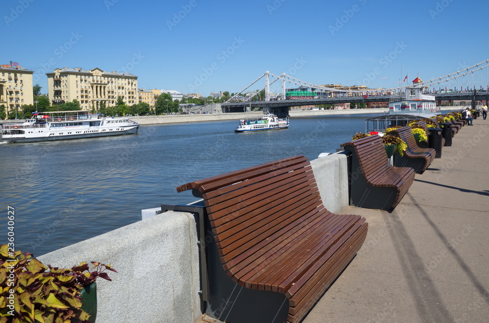 Moscow, Russia - June 15, 2018: Summer view from Gorky Park embankment to the Crimean bridge and the Moscow river with pleasure boats Moscow, Russia - June 15, 2018: Summer view from Gorky Park embankment to the Crimean bridge and the Moscow river with pleasure boats