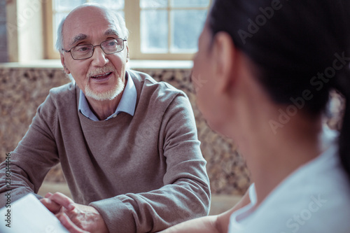 Handsome mature male person looking at his interlocutor