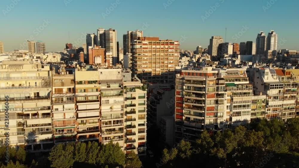 Panoramic Aerial drone view of Palermo Neighborhood in Buenos Aires during sunset with city park and skyscrapers buildings. Warm orange colors. Panoramic Aerial drone view of Palermo Neighborhood in Buenos Aires during sunset with city park and skyscrapers buildings. Warm orange colors.