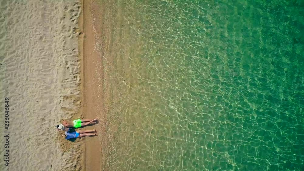 Beautiful beach with family top aerial view drone shot, Sithonia, Greece Beautiful beach with family top aerial view drone shot, Sithonia, Greece