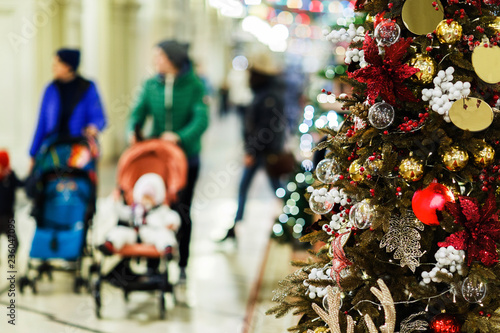 Wallpaper Mural Photo of decorated spruce in store on background of moms with strollers Torontodigital.ca
