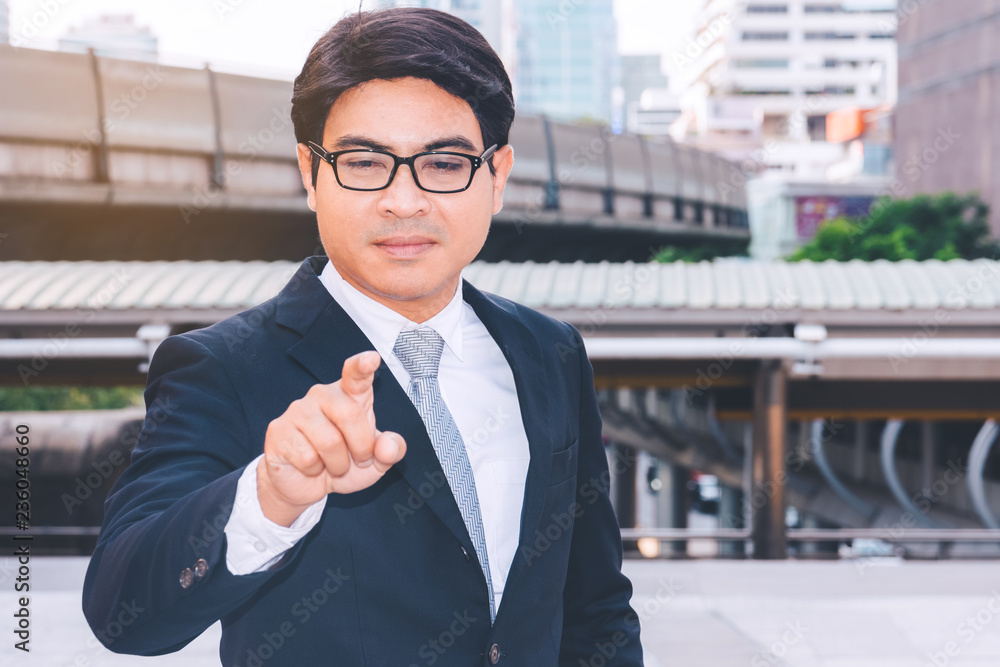 Portrait of a young successful businessman standing in city Portrait of a young successful businessman standing in city