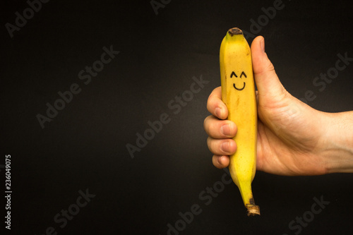 they took a banana in his hand and he likes it very much and he is pleased and smiles