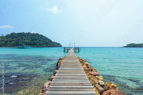 Long wooden bridge go to the sea in beautiful tropical island, Thailand.