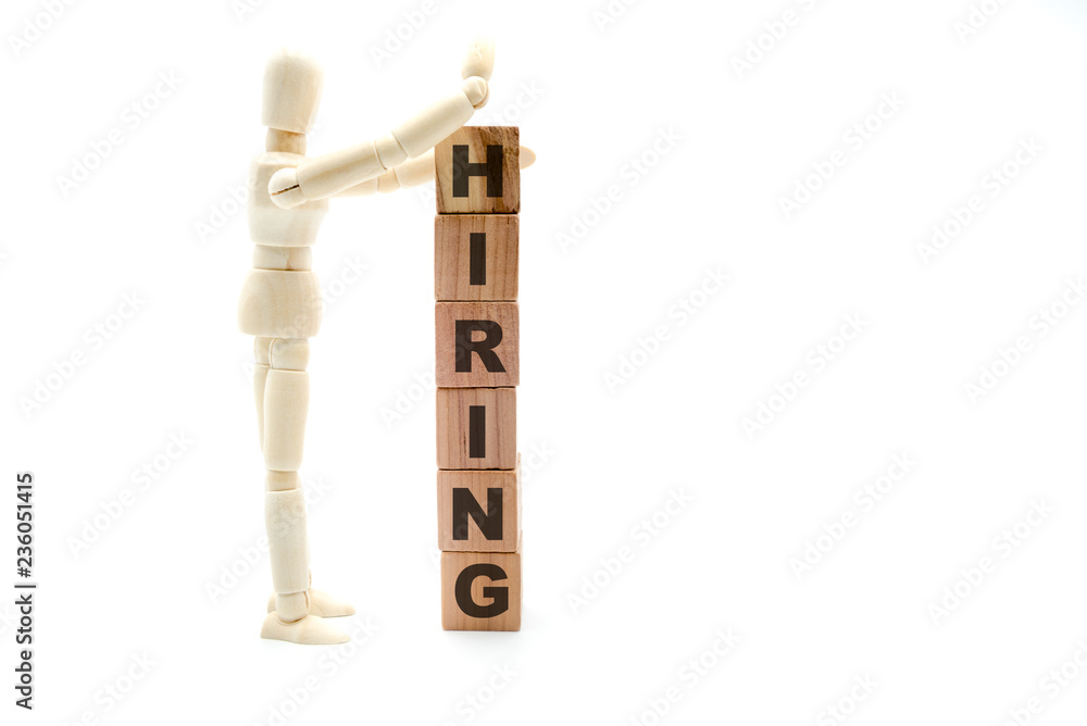 Wooden figure as businessman building Hiring concept as tower of wood cubes Wooden figure as businessman building Hiring concept as tower of wood cubes