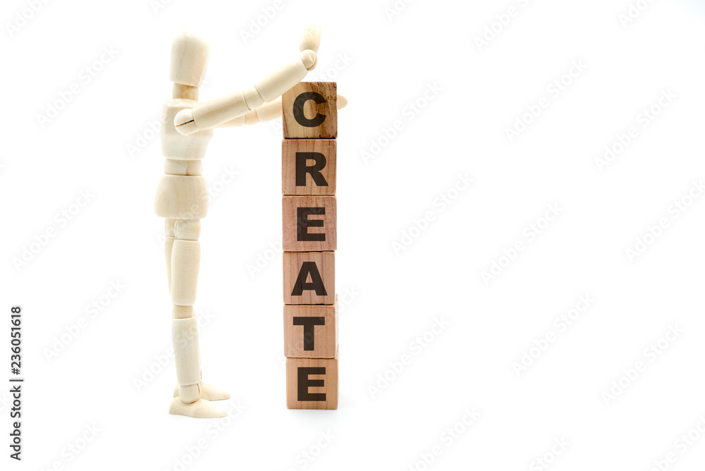 Wooden figure as businessman building Create concept as tower of wood cubes Wooden figure as businessman building Create concept as tower of wood cubes