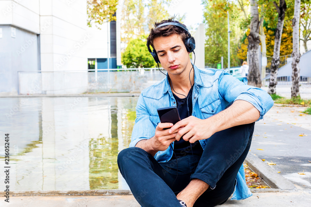 Obraz premium Man sitting listening music Headphones concept