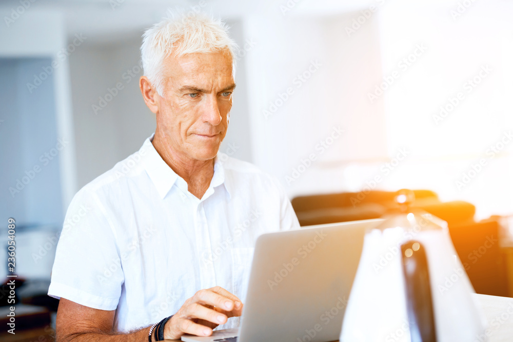 Man working on laptop at home Man working on laptop at home
