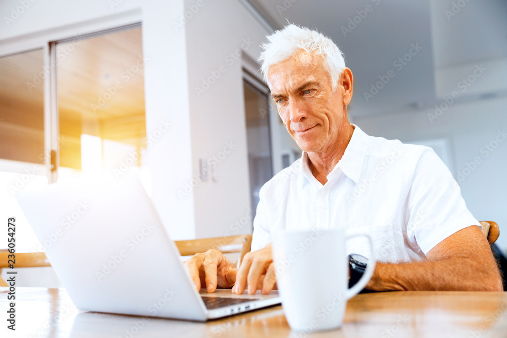 Man working on laptop at home Man working on laptop at home