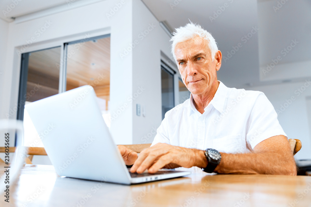 Man working on laptop at home