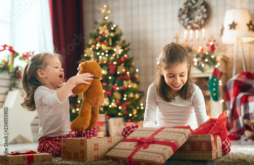 girls opening Christmas gifts