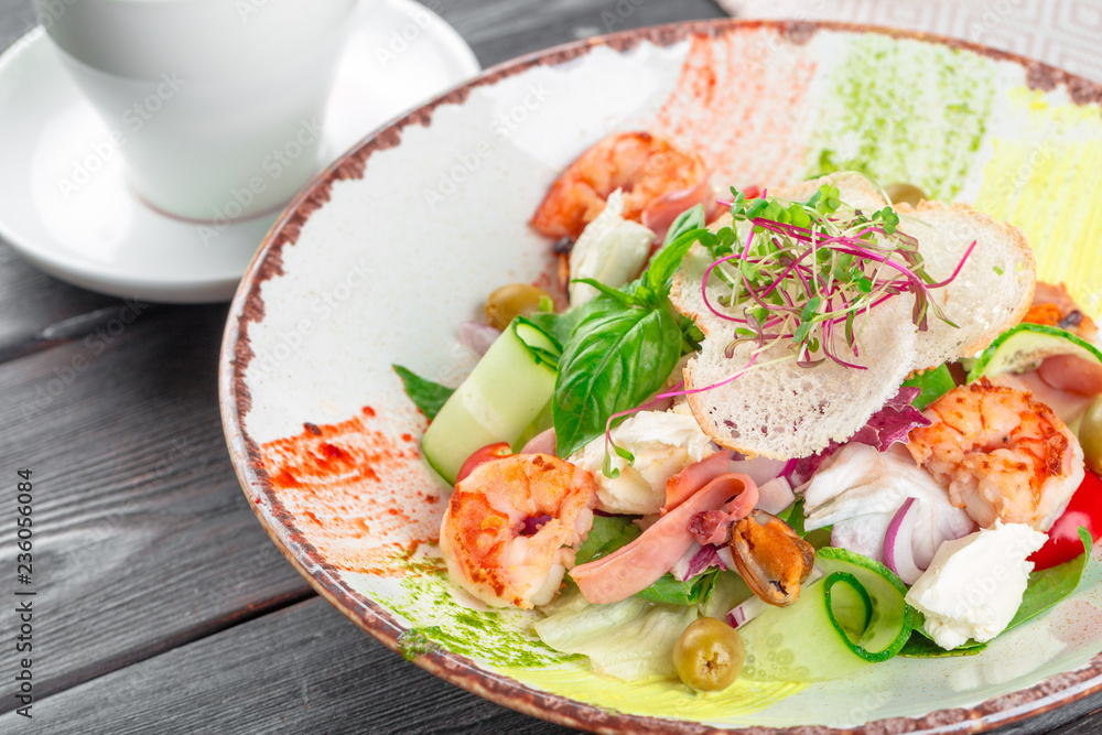 Fresh seafood salad served with prawns and greens Fresh seafood salad served with prawns and greens