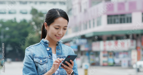 Photography Woman use of mobile phone in the street of Hong Kong