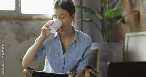 Young woman using digital tablet computer in home photo