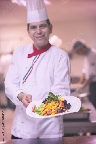 Chef showing a plate of tasty meal