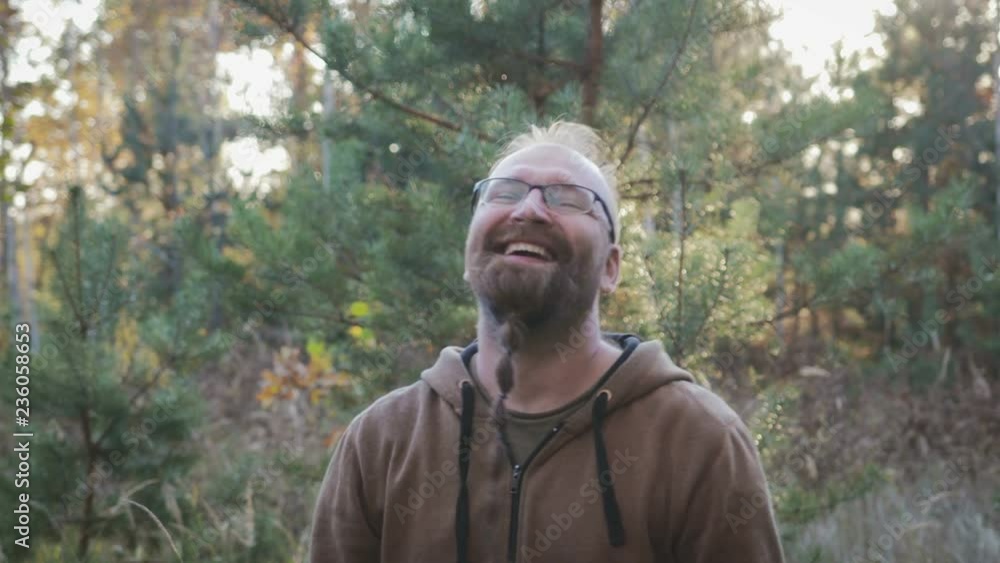 The average pocket plan of a charismatic adult man in a good mood. The object in rectangular glasses with a black frame and a beard pigtail Garibaldi smiles looking at the camera The average pocket plan of a charismatic adult man in a good mood. The object in rectangular glasses with a black frame and a beard pigtail Garibaldi smiles looking at the camera