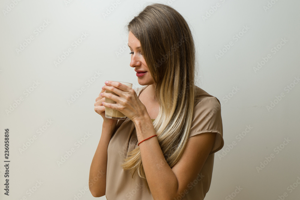 Girl is holding a cup of coffee and smiling Girl is holding a cup of coffee and smiling