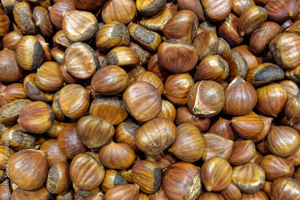 pile of chestnuts in shell closeup, horizontal view from above pile of chestnuts in shell closeup, horizontal view from above