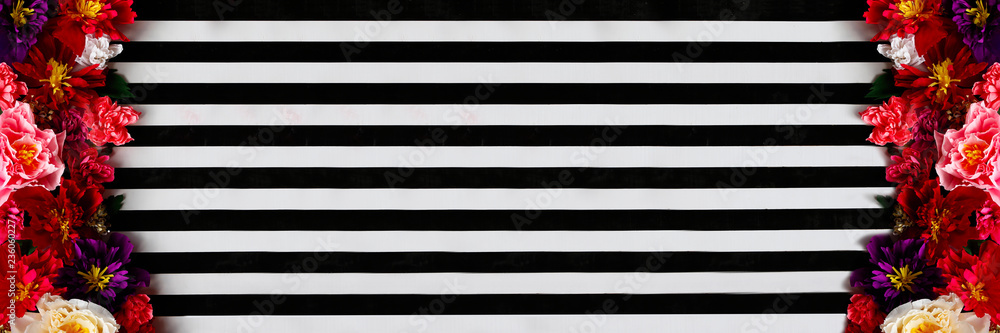 Wooden texture with black and white stripes embellished with flowers.Flower decorated strips Wooden texture with black and white stripes embellished with flowers.Flower decorated strips