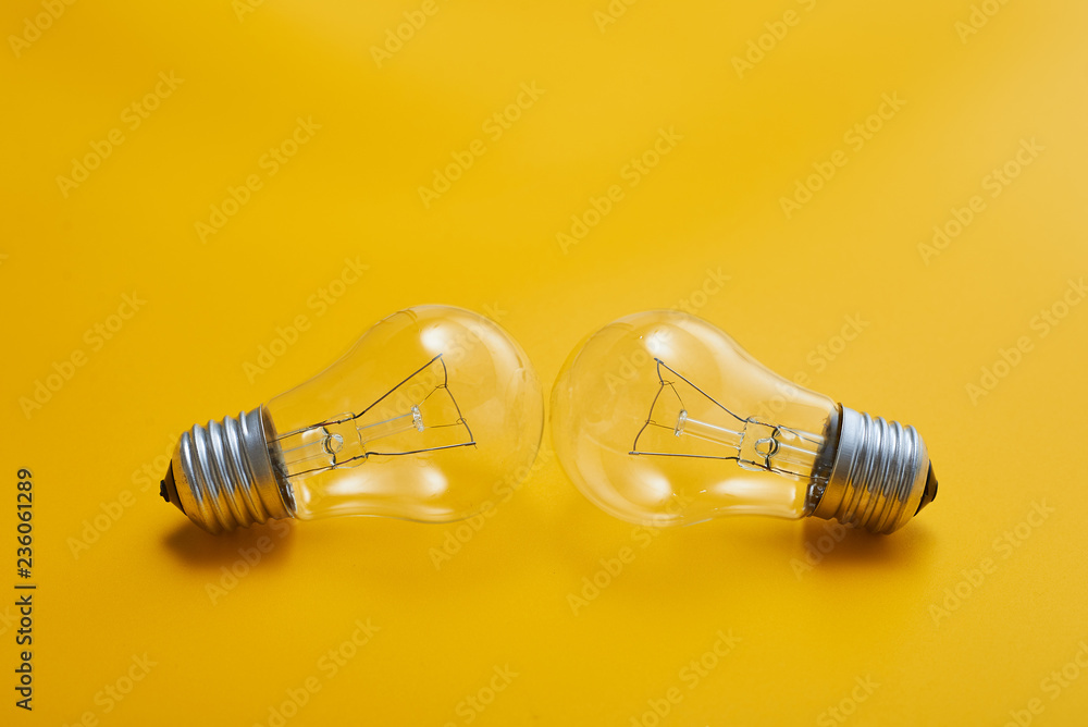 close up view of white light bulb isolated on yellow close up view of white light bulb isolated on yellow